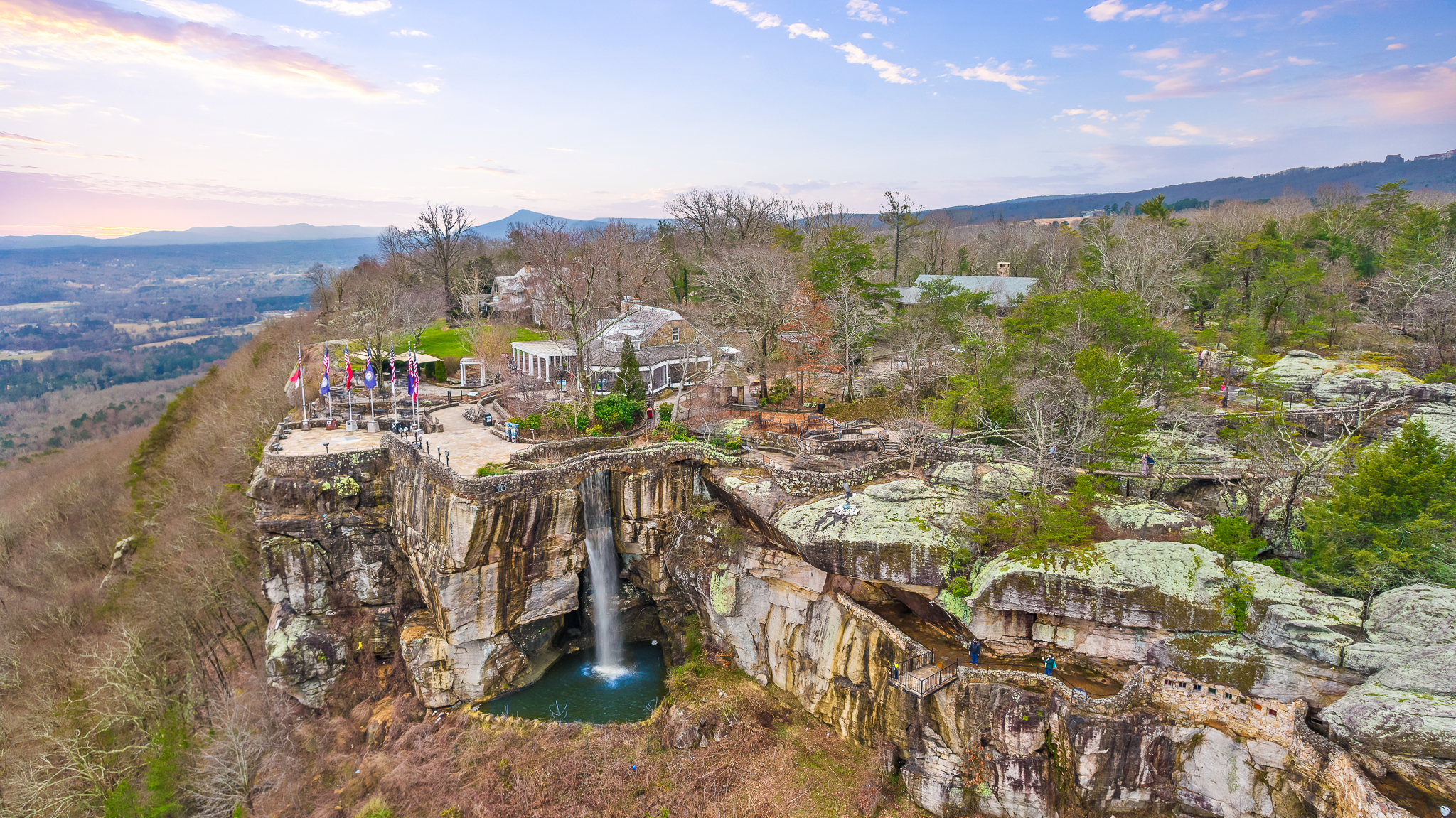 Stunning clifftop views with a waterfall and panoramic mountain scenery