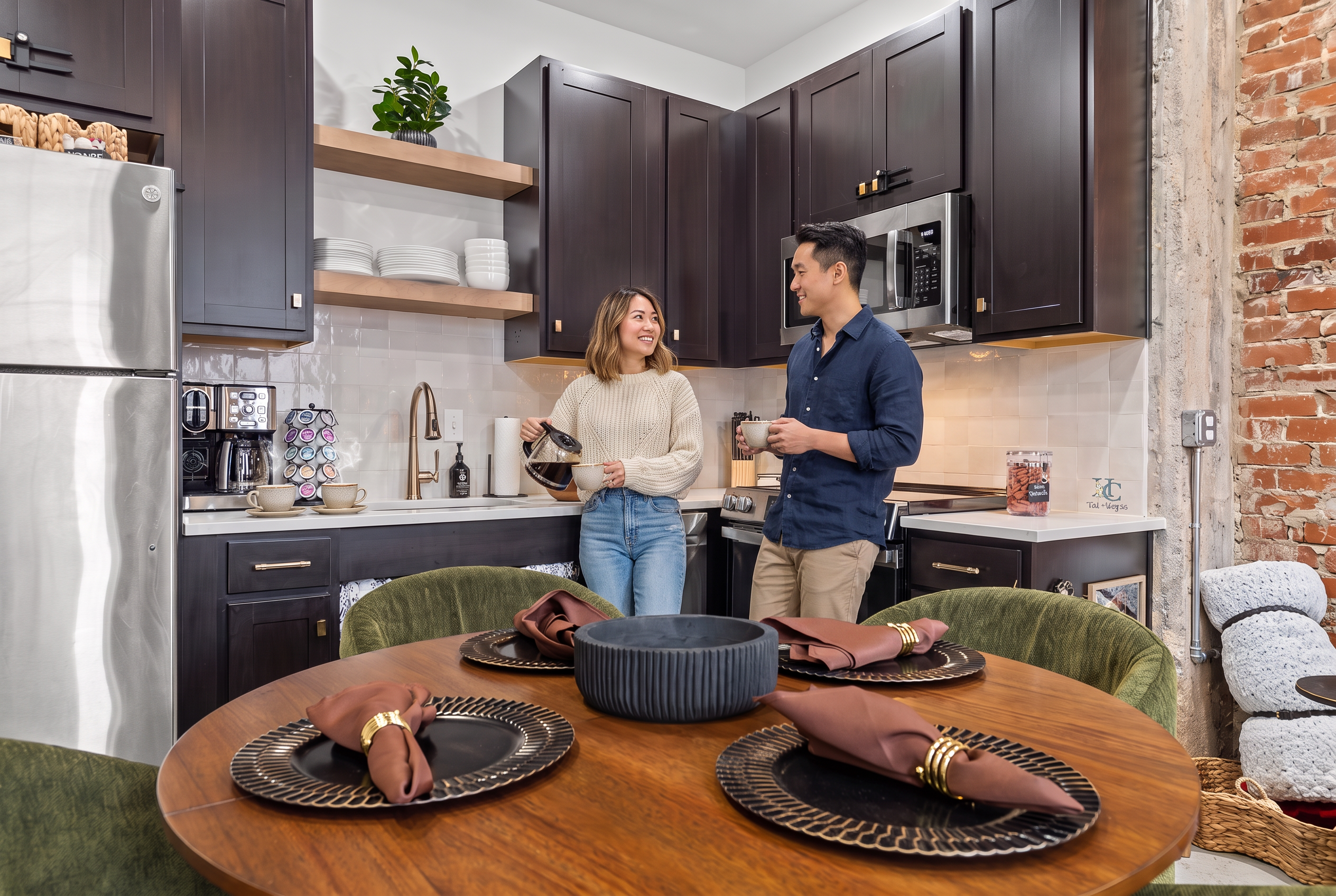 Modern kitchen with exposed brick and cozy dining for four