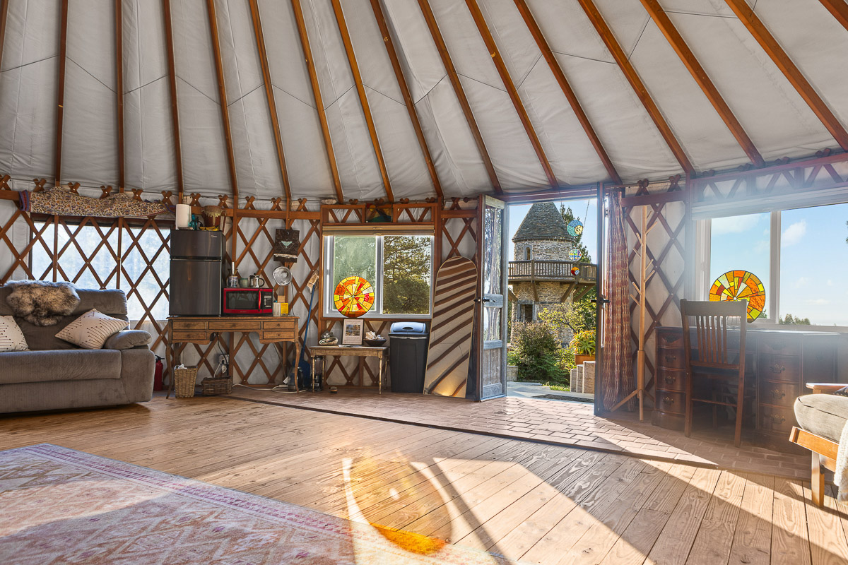 Sunny yurt retreat with cozy lounge, desk, and garden views