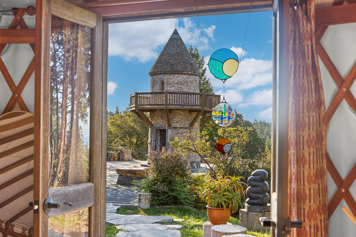 Whimsical stone tower and garden view from cozy yurt retreat w/ deck
