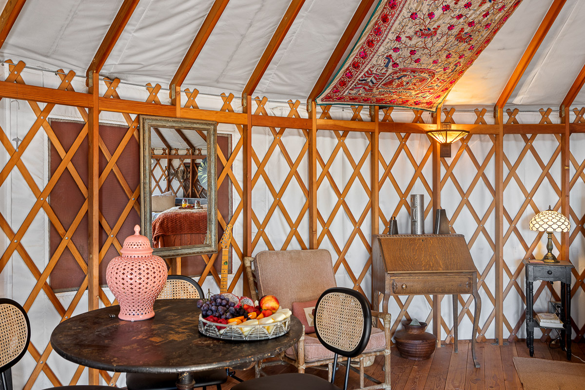 Charming yurt lounge with vintage decor and warm, cozy lighting