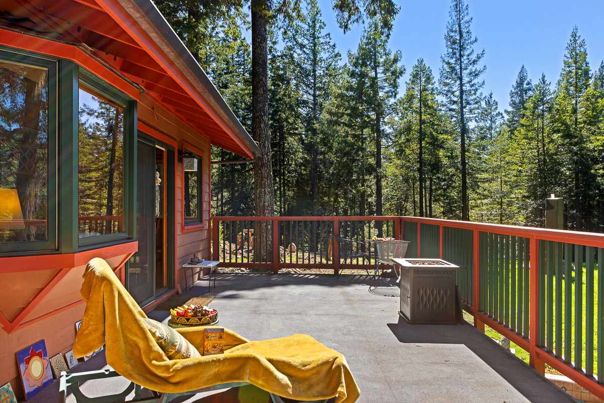 Spacious forest-view deck with fire table—sunny, serene escape