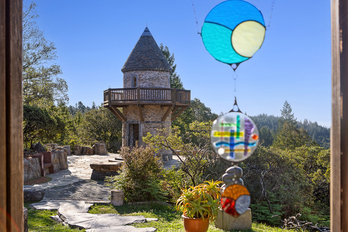 Fairytale stone tower with deck and forest views—serene retreat