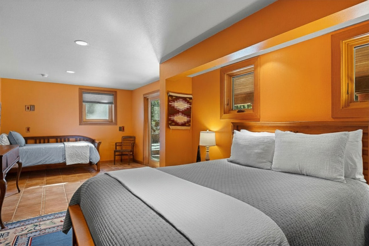 Sunny retreat with king bed, daybed, patio access, and desk