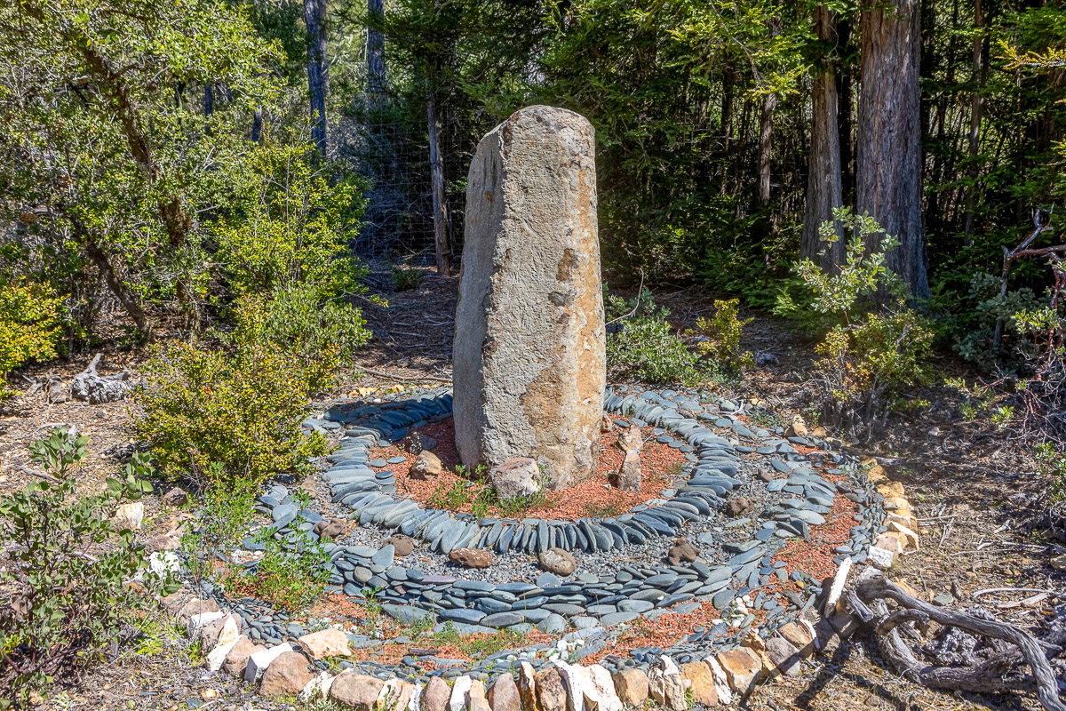 Tranquil forest garden with a stone monolith and rock circle