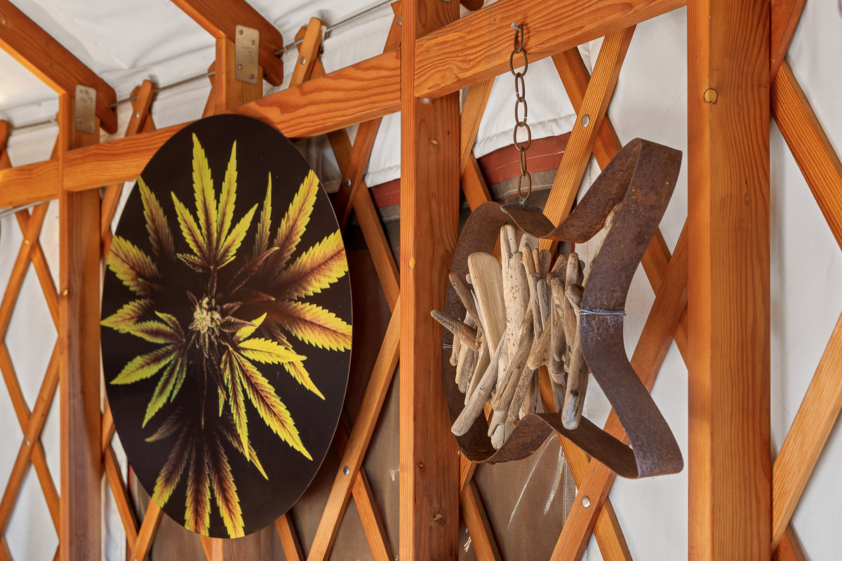 Rustic yurt lattice with botanical art and driftwood accents for a boho vibe.