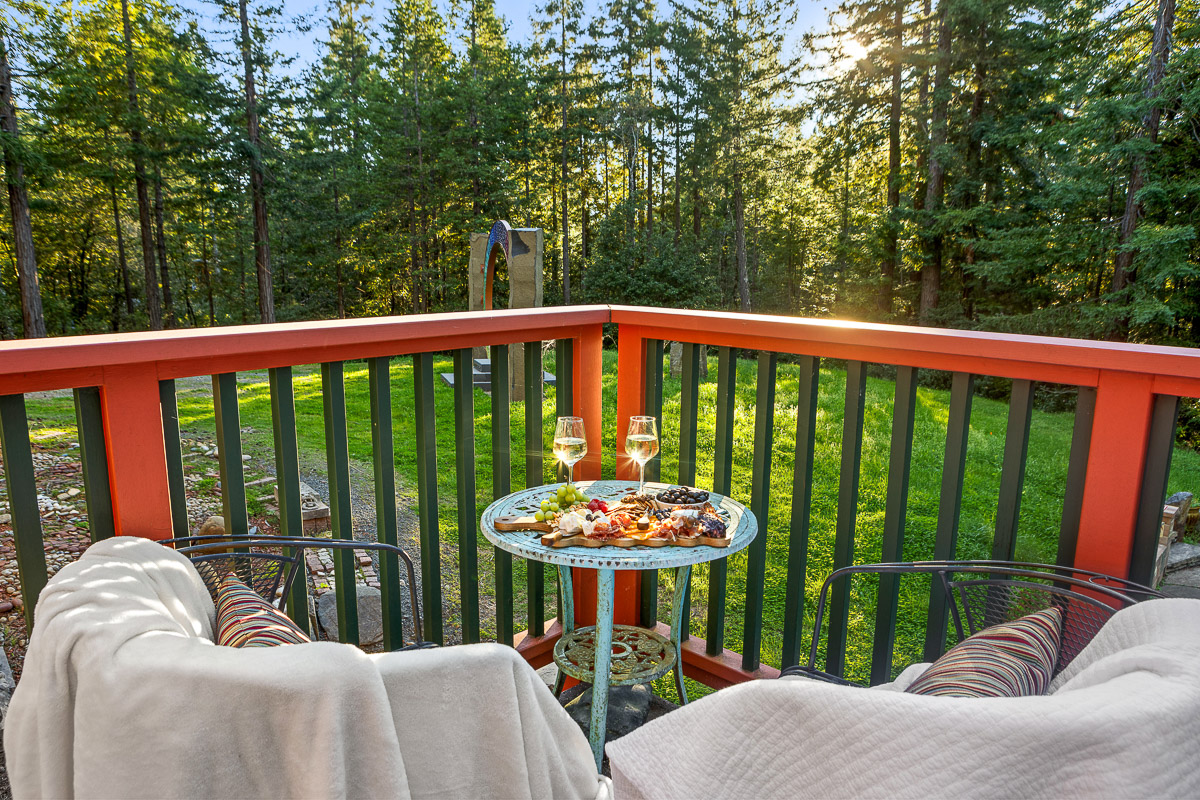 Cozy forest-view deck with wine-ready seating for golden sunsets