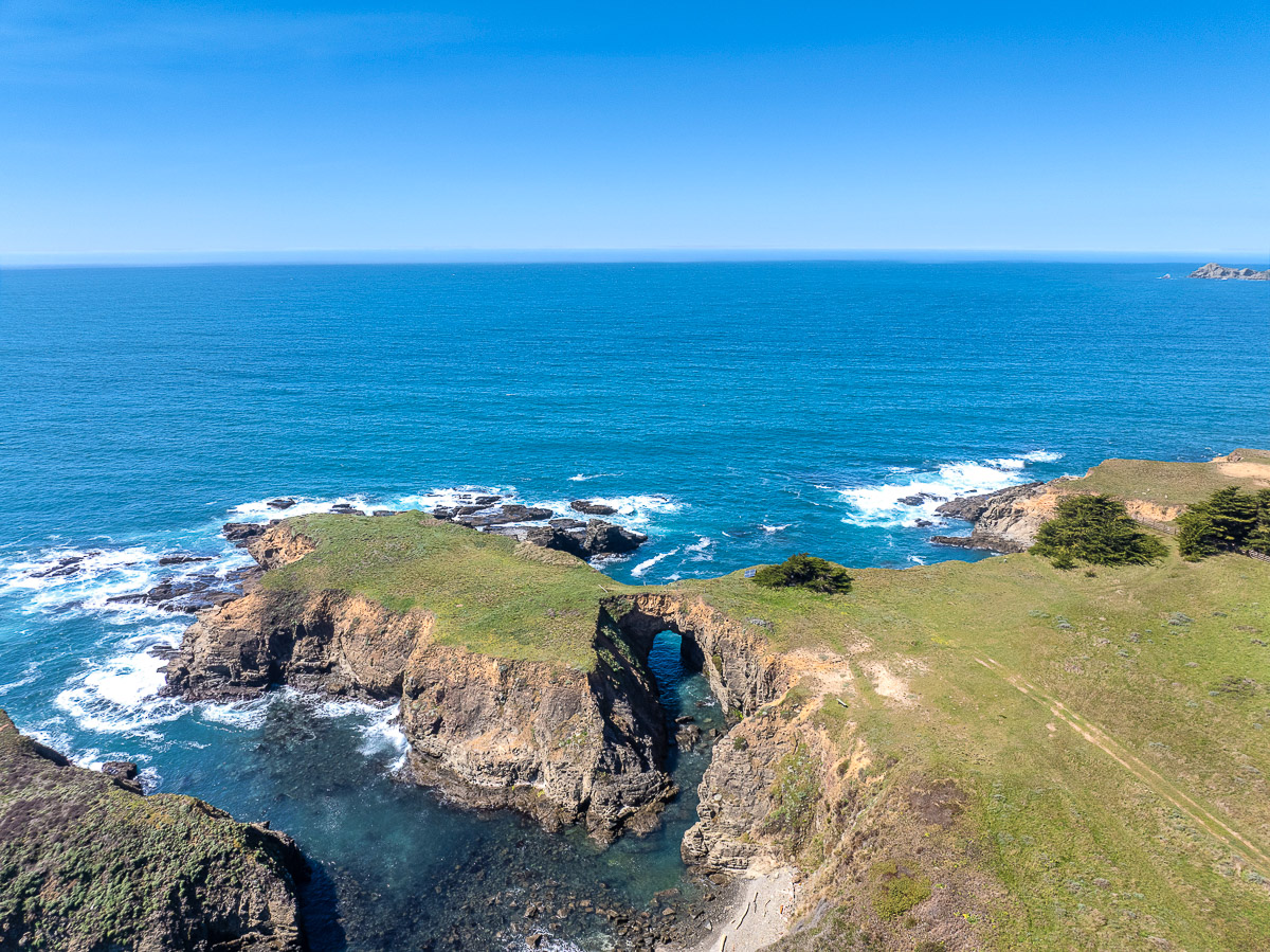 Dramatic sea-arch views from rugged oceanfront bluffs—coastal escape