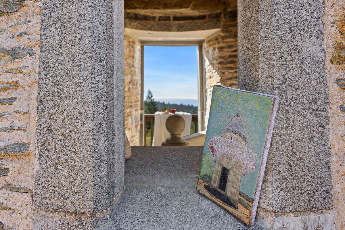 Romantic stone turret nook with terrace dining and valley views.
