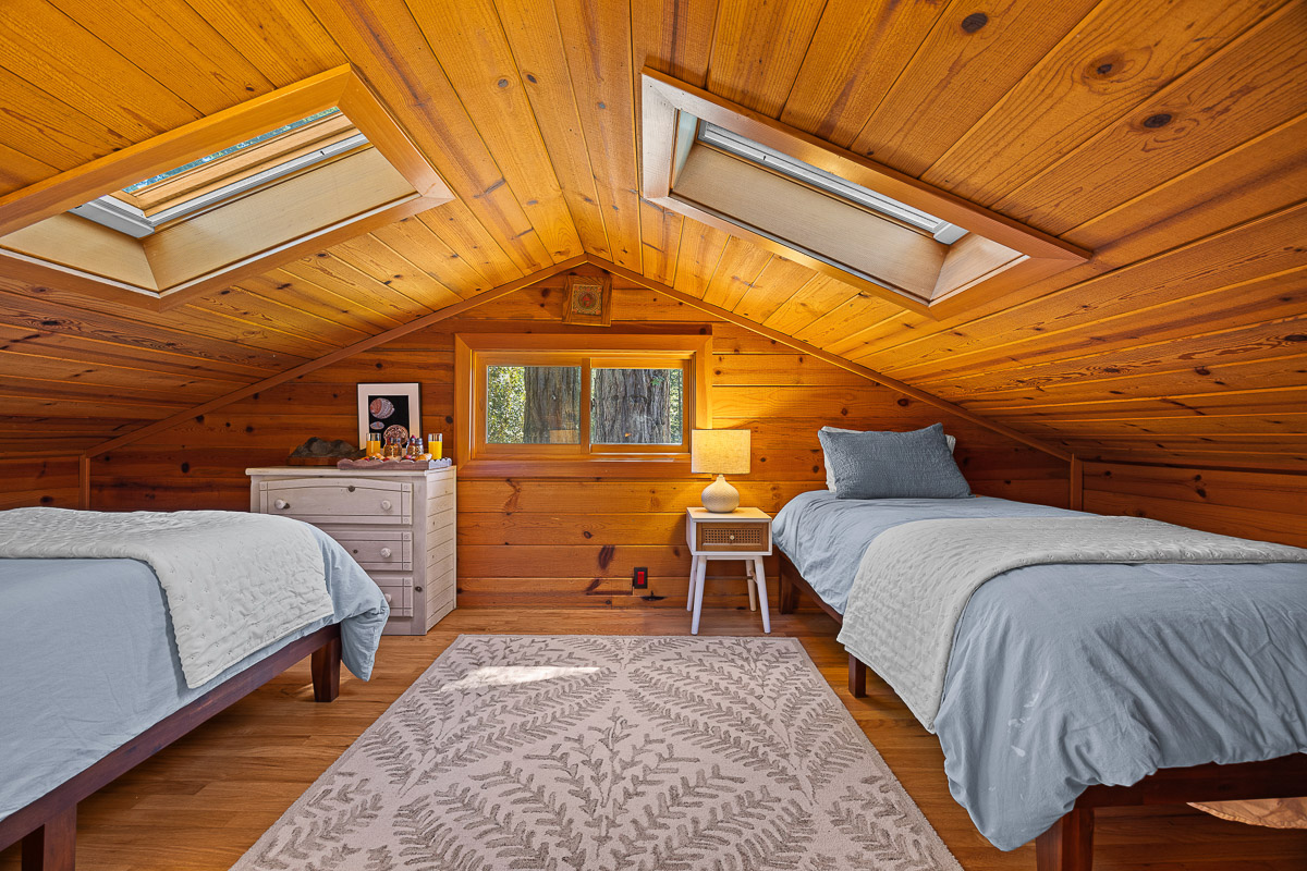 Cozy loft with twin beds, skylights & woodsy charm—perfect for kids