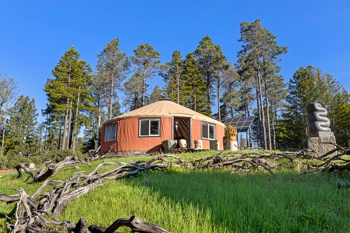 Secluded solar-powered yurt amid pines—artful, eco-chic forest escape.