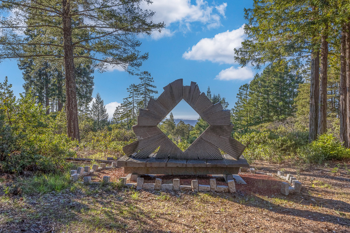Sculpture lookout amid redwoods with framed ocean and mountain views