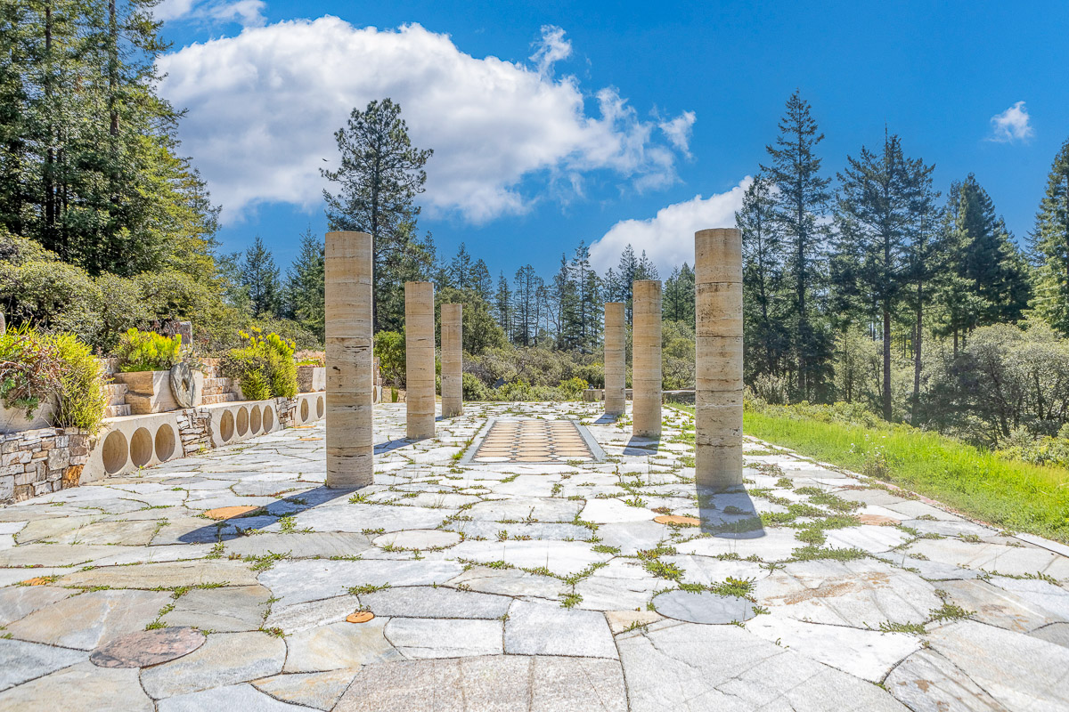 Sculptural stone terrace with forest views—perfect for events