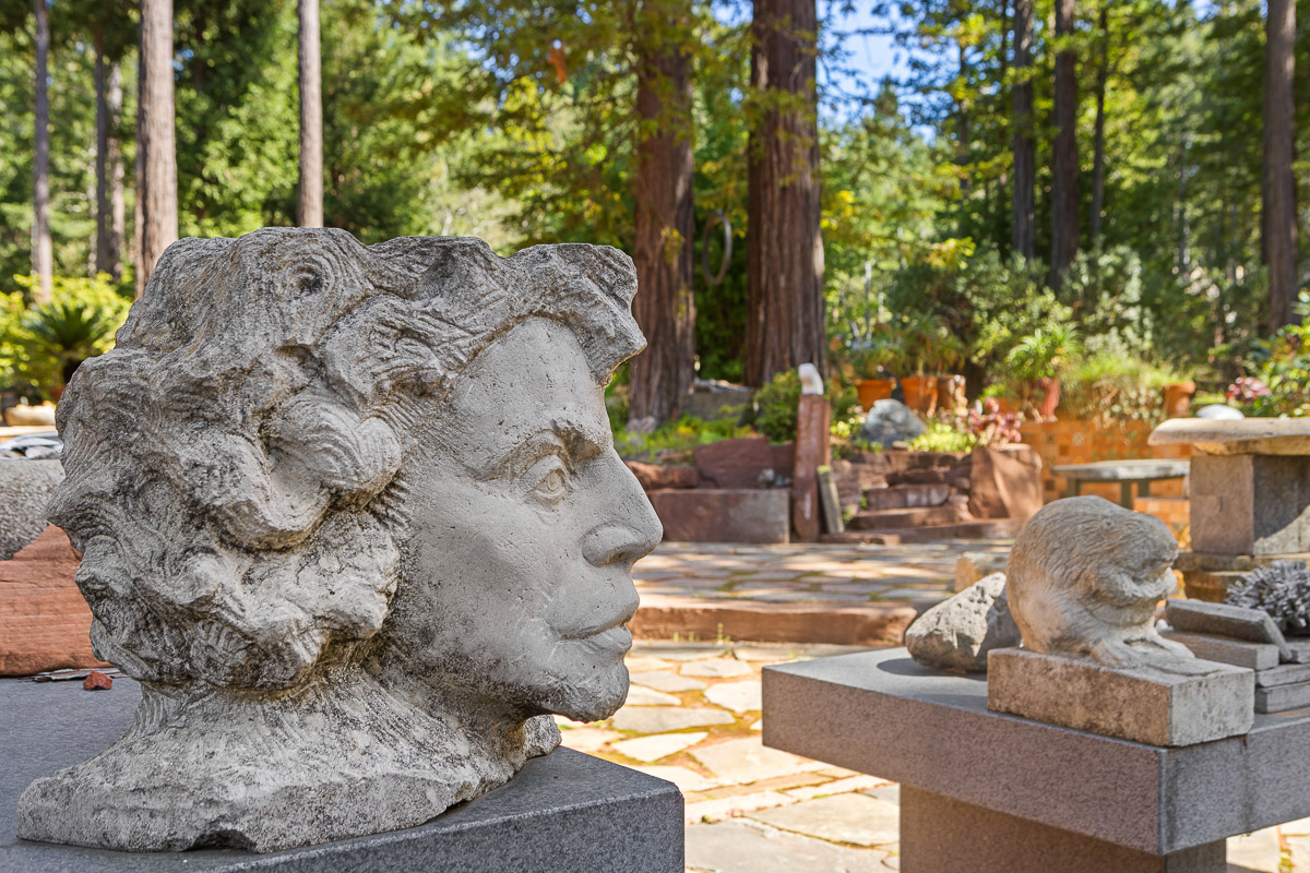 Serene redwood retreat with art-filled stone patio and sculptures