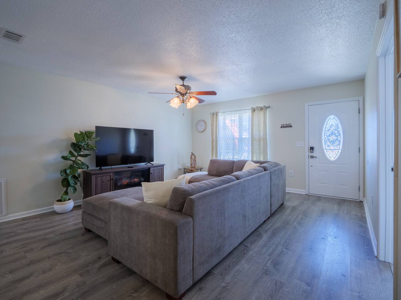 Living room with sectional and front door