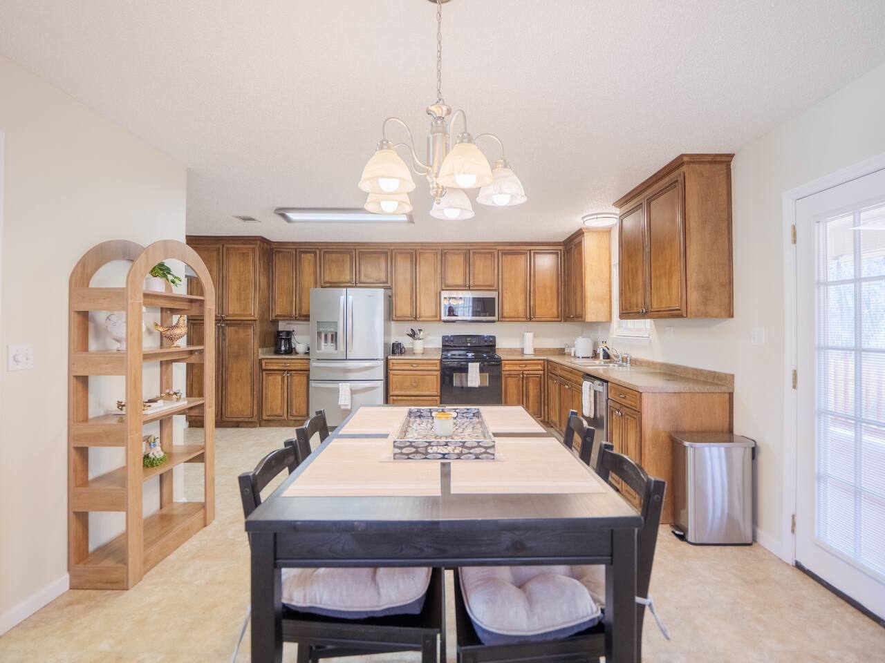 Kitchen with honey wood cabinets and pub-height dining table
