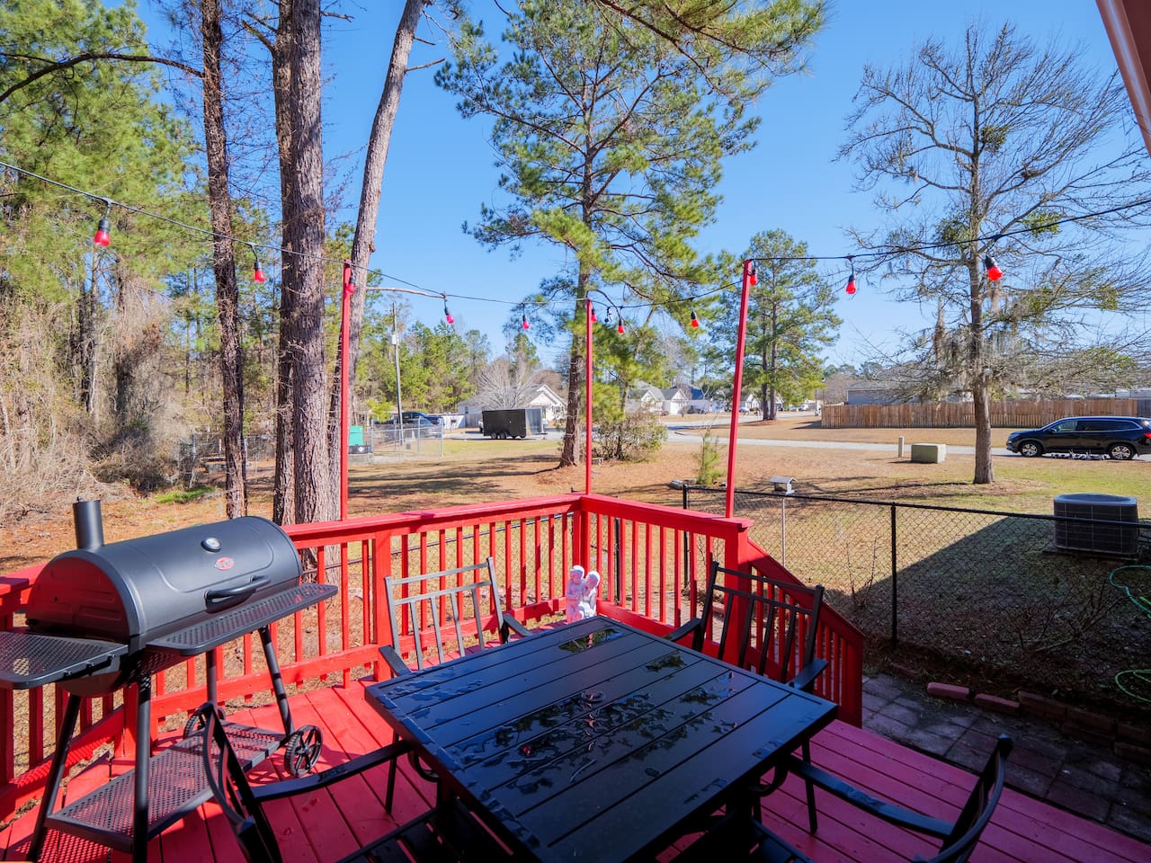 Deck with charcoal grill and dining table