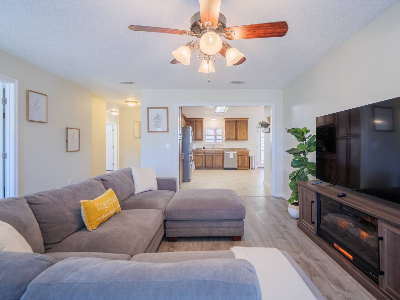 Living room with electric fireplace below the flat-screen TV