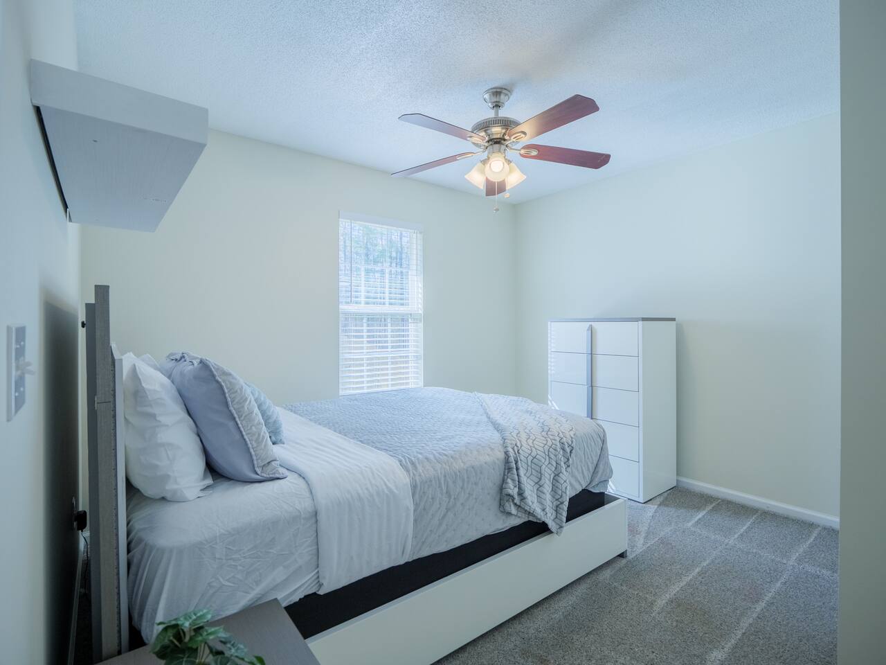 Second bedroom with white platform bed