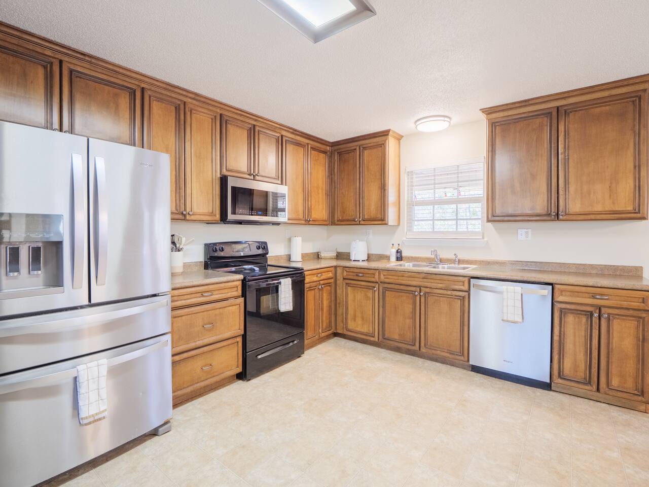 Kitchen with French-door refrigerator, gas range and dishwasher