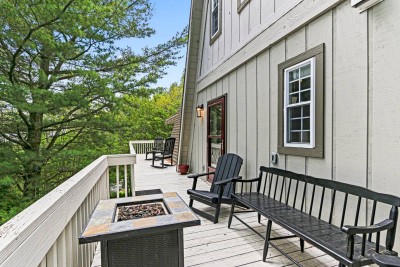 Relax on the spacious wraparound deck with outdoor seating perfect for morning coffee or evening wine. Surrounded by trees, this outdoor space feels like your own private forest lounge.