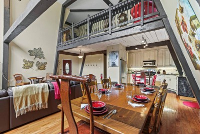 Gather around the dining table under dramatic beams and balcony views. Whether it is brunch, board games, or celebratory dinners, this inviting space brings everyone together.