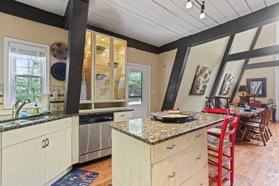 Another view of the spacious kitchen shows generous prep space and natural light. Perfect for morning pancakes, late night snacks, and everything in between.