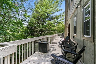 Another angle of the peaceful deck retreat, where forest views stretch beyond the railing. Ideal for slow mornings, afternoon reading, or simply breathing in fresh air.
