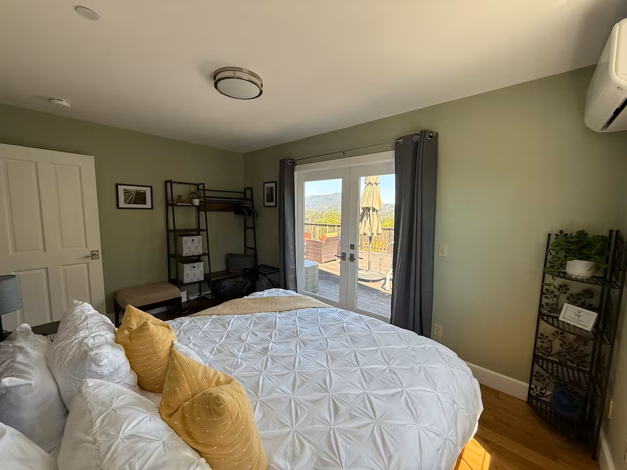 Sunny bedroom with deck access, mountain views, and cozy AC comfort
