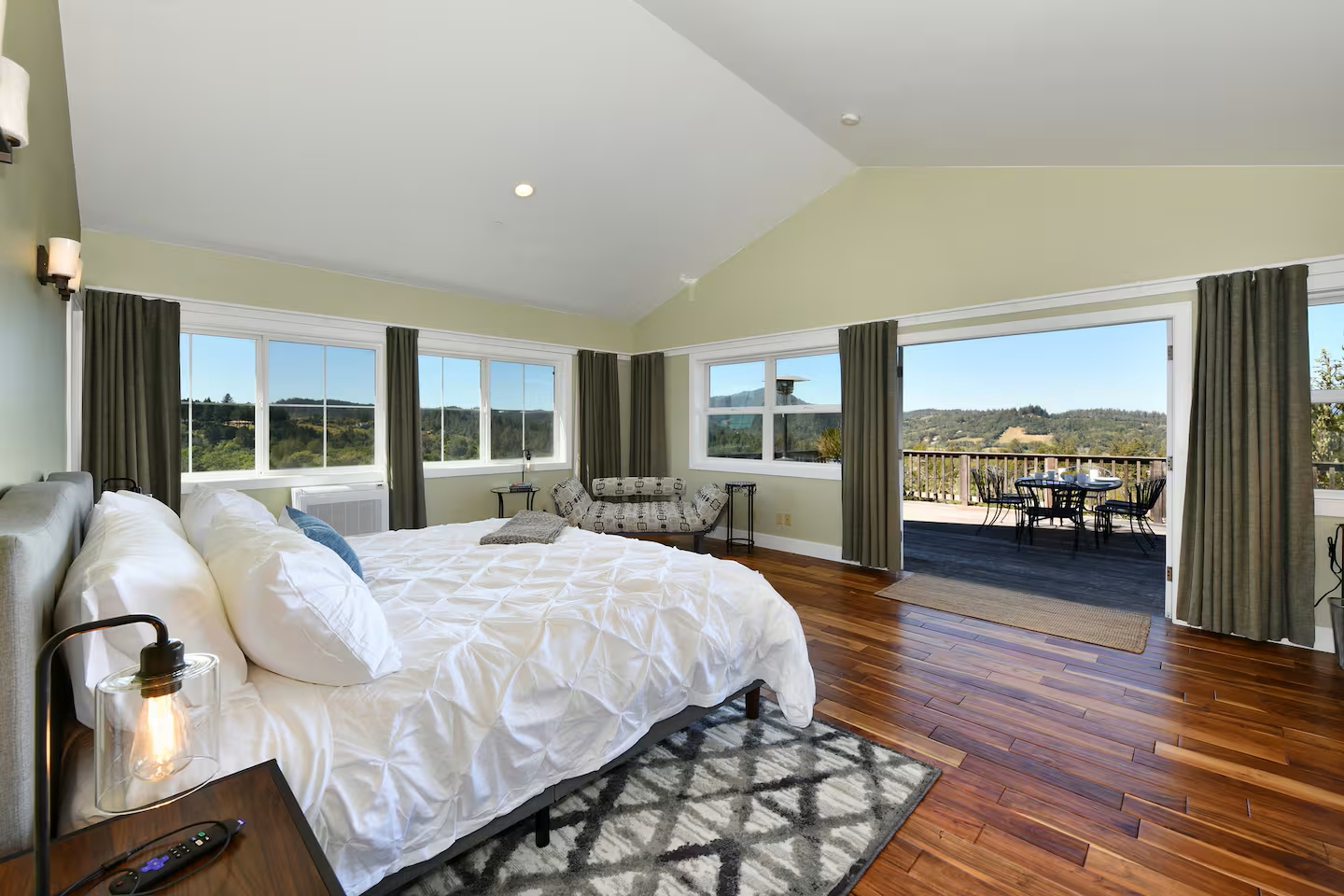 Sunny primary suite with private deck, vaulted ceiling and sweeping valley views