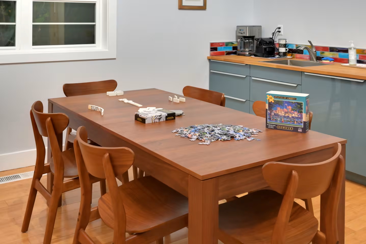 Sunny dining nook with games and a stocked coffee bar