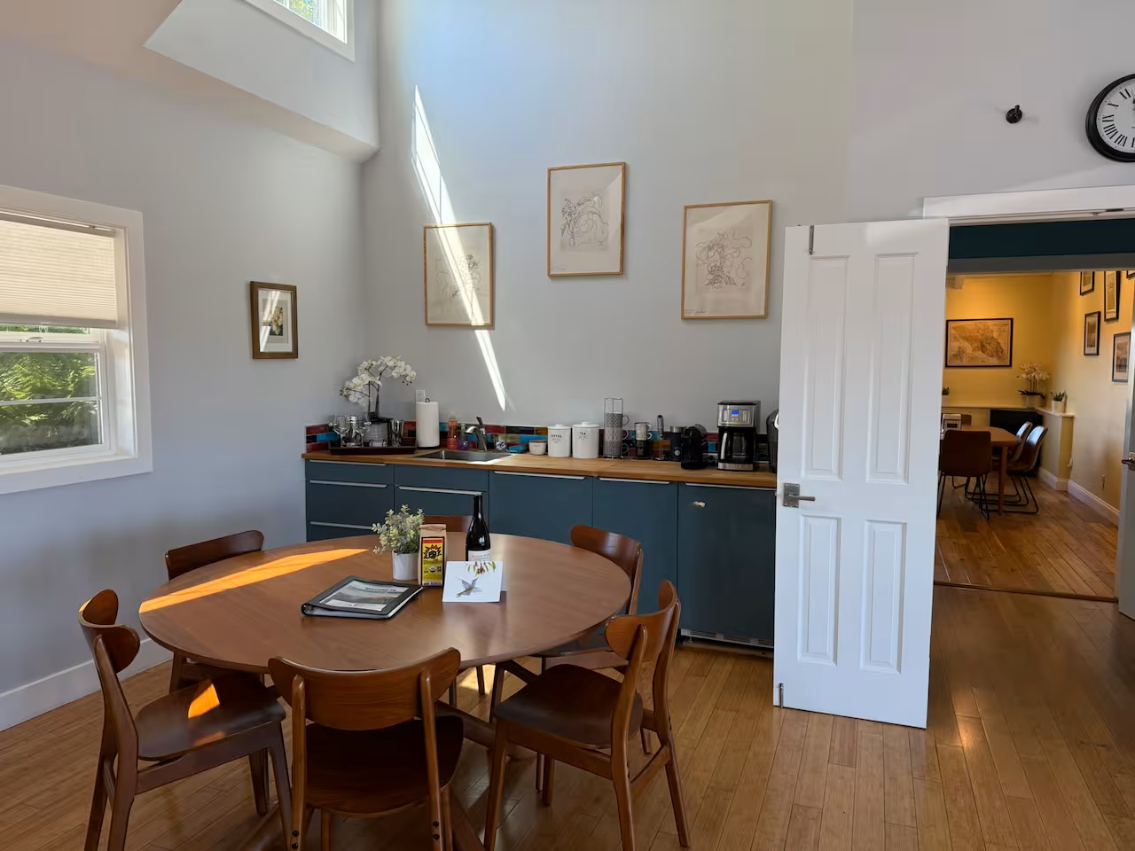 Sunny dining nook with coffee bar, high ceilings, and mid-century charm