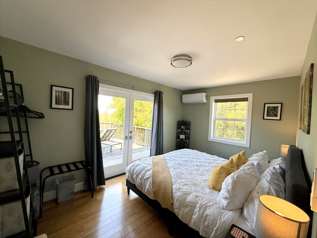 Bright bedroom with private deck, treetop views, and AC comfort.