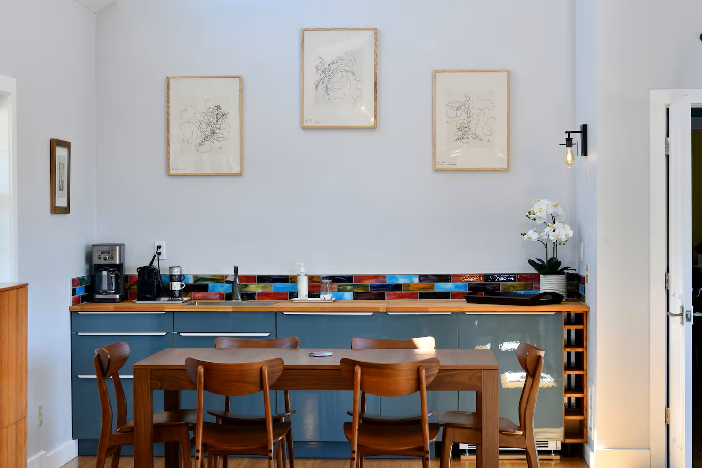 Sunny kitchen-diner with coffee bar, wine rack & colorful flair