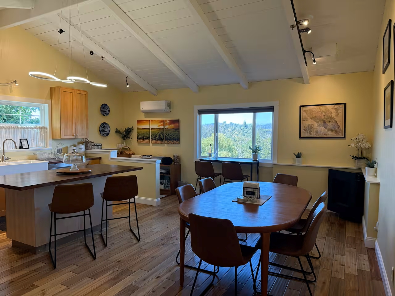 Sunny open kitchen & dining with island seating and sweeping valley views