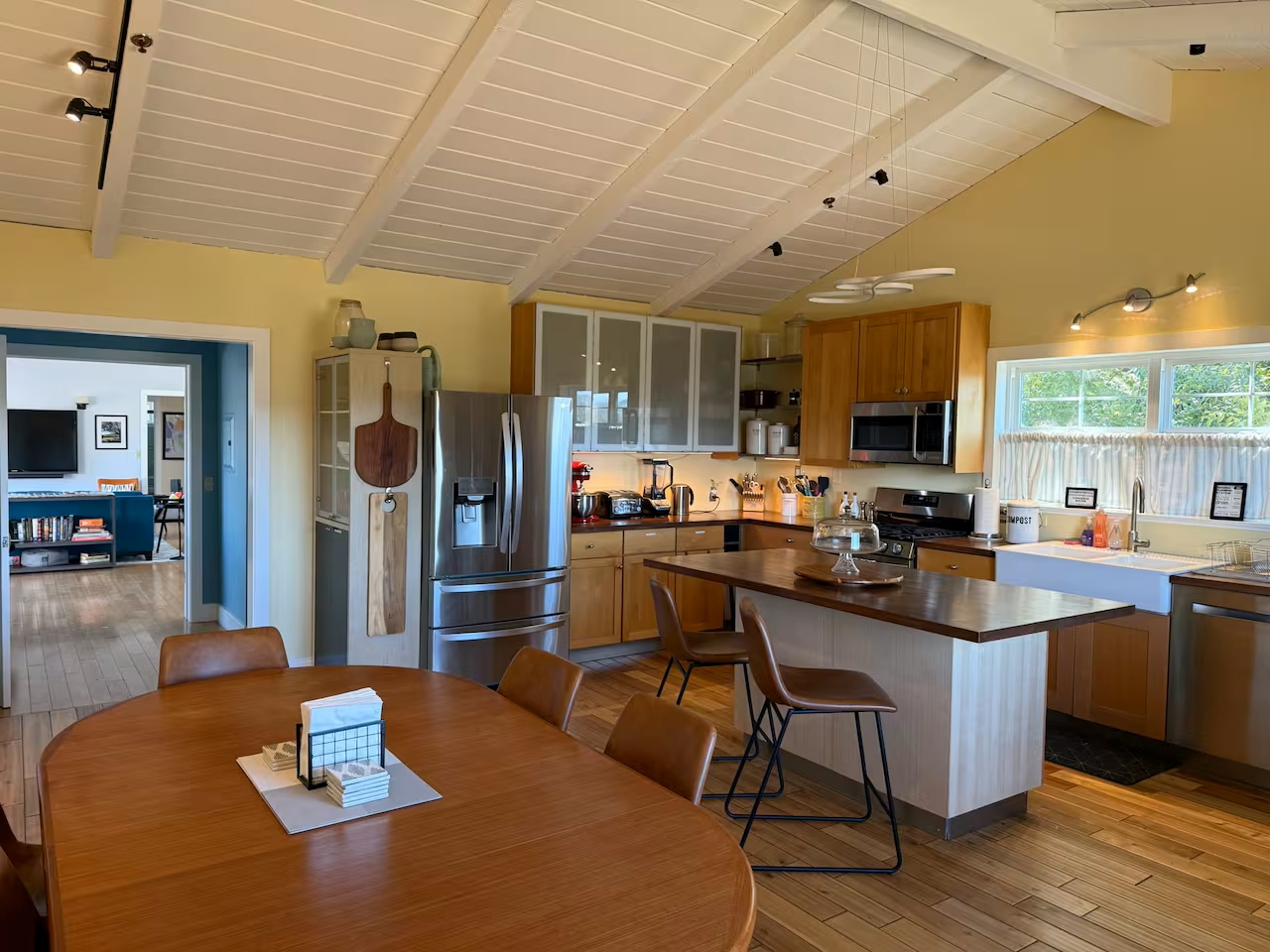 Sunny vaulted kitchen with island seating, stainless and farmhouse sink