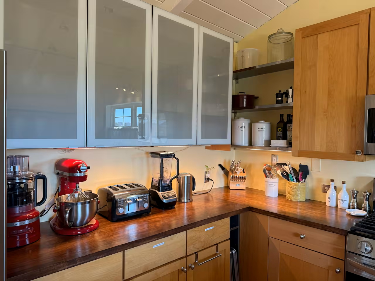 Well-equipped chef’s kitchen with gadgets, wood counters & storage