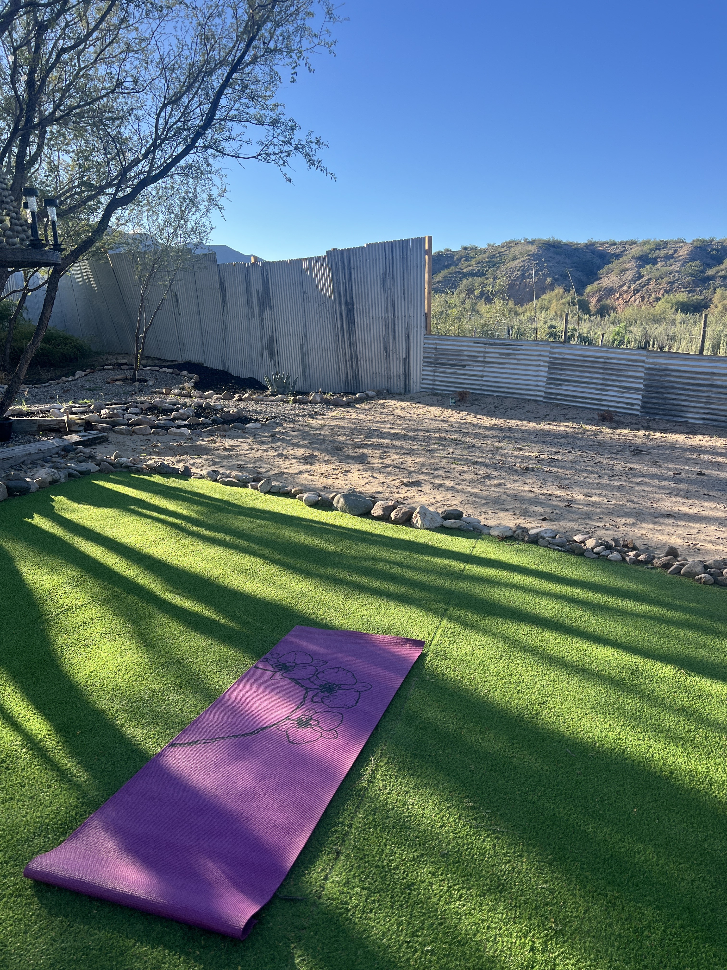 Peaceful turf yoga spot with mountain views and sunny outdoor space