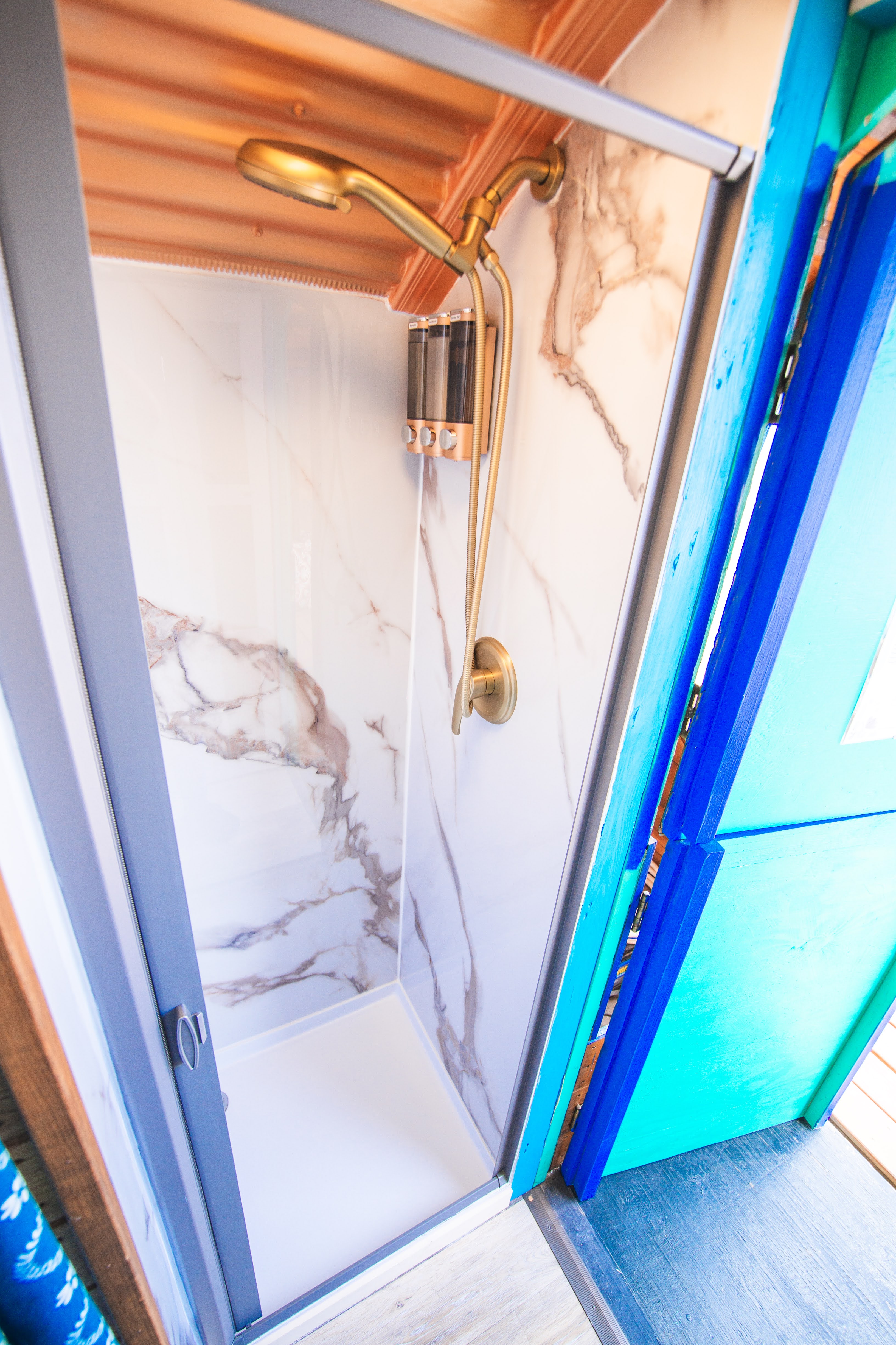 Shower at front of Wagon, small but great for rinsing post hot springs soaks, Shower has sliding door and there's an additional curtain in the hallway for privacy.
