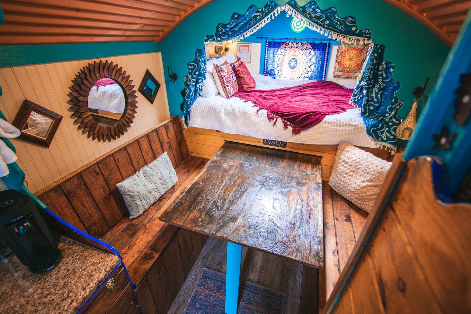Slide out dining table with benches on either side (benches double as storage for the lower sleeping cubbies and as steps to get up into the upper sleeping cubby).