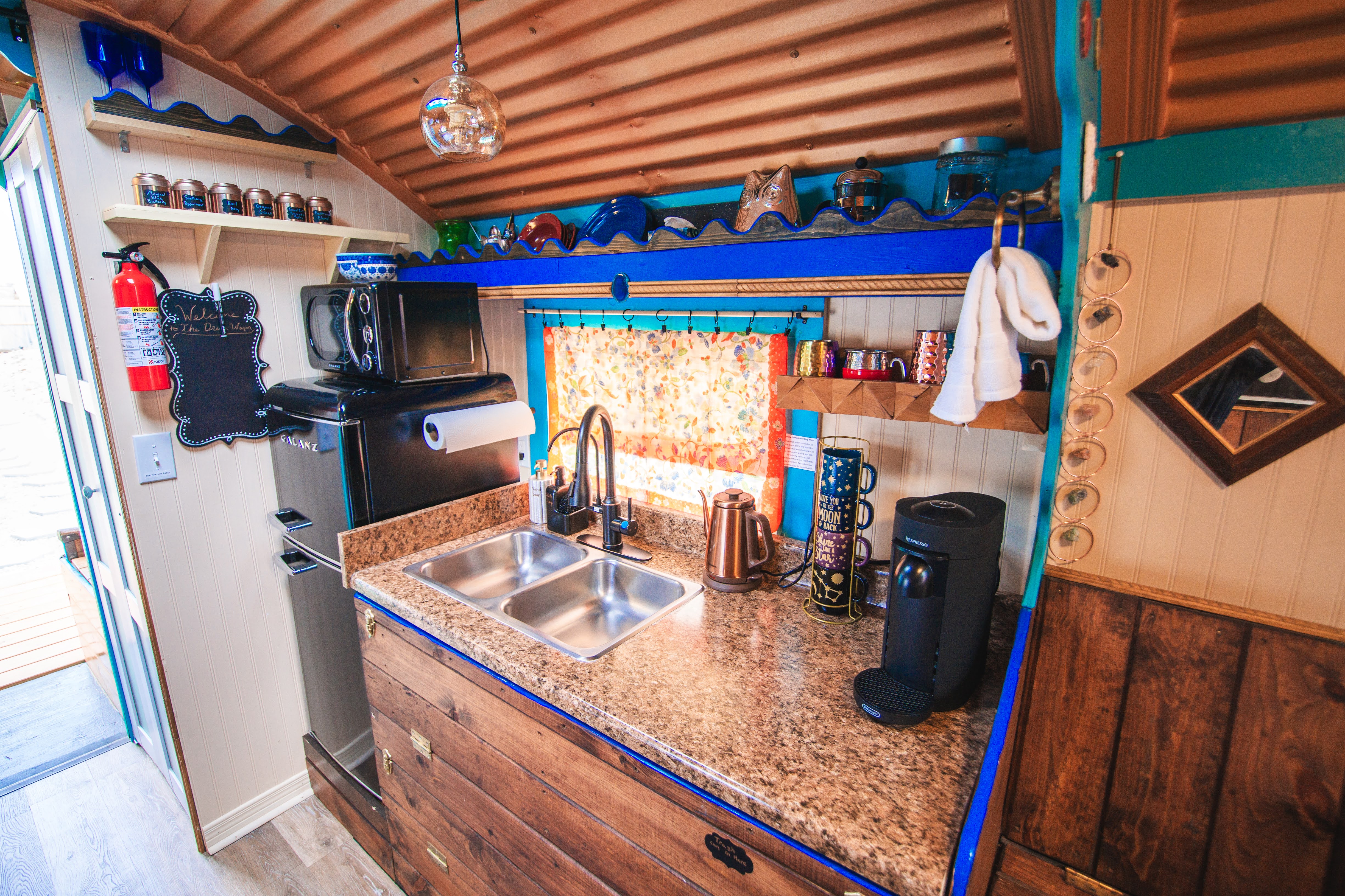 Charming rustic kitchenette with coffee station and colorful character
