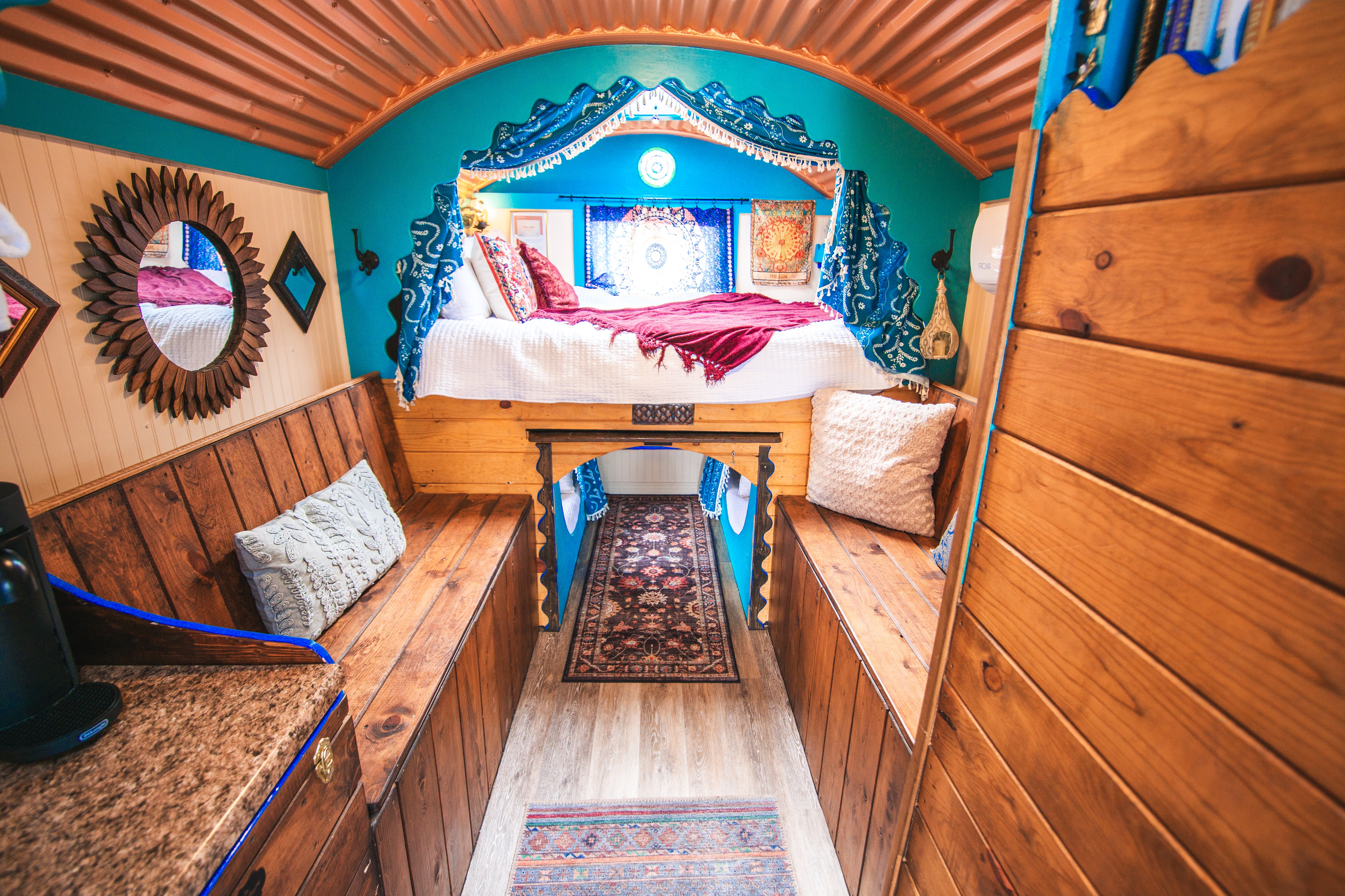 Charming boho tiny retreat with a loft-style bed and warm wood details