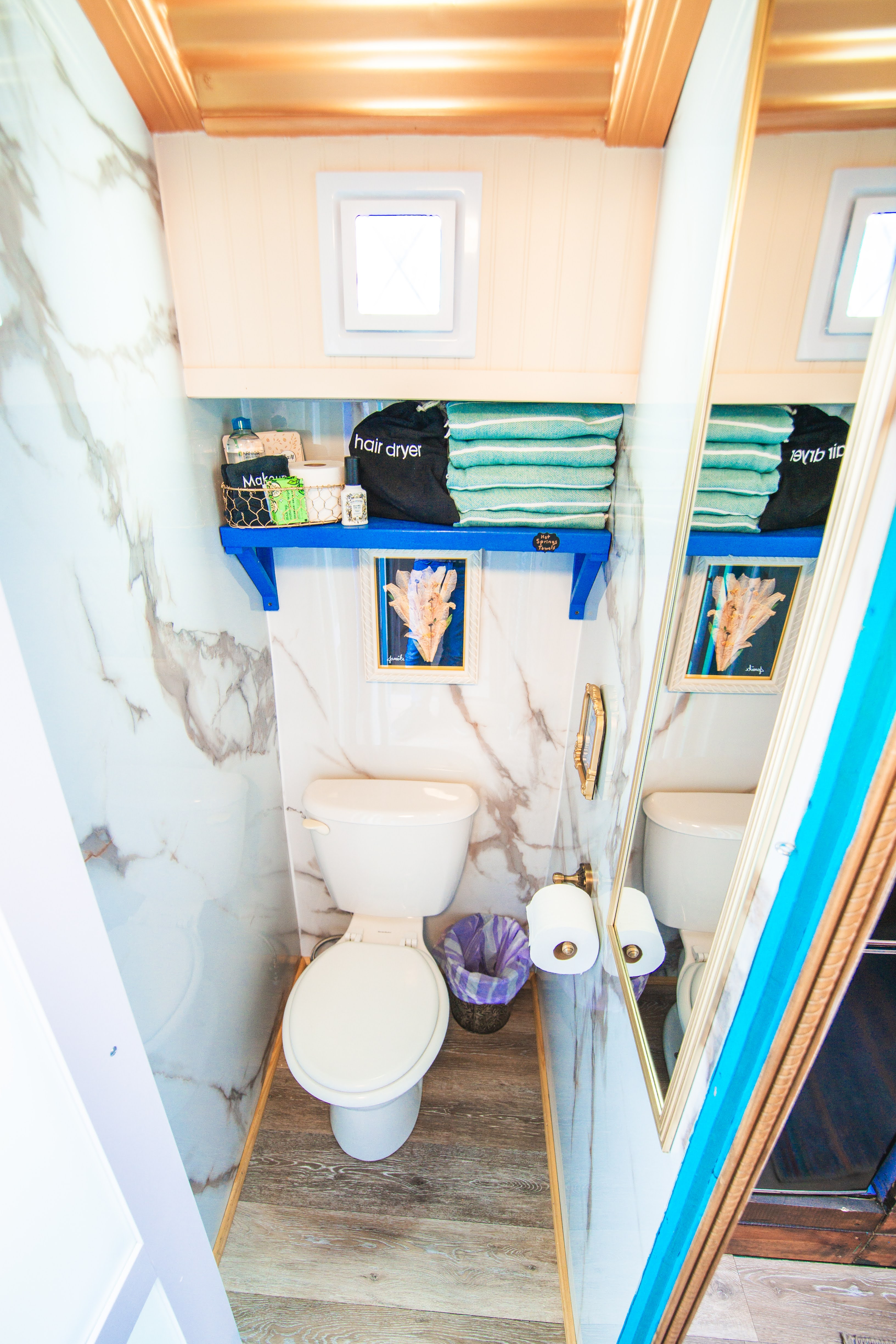 Water Closet with Toilet and Plenty of Supplies (Hot Springs Towels, extra TP, tissues, micellar water, makeup washcloths, and sheet face masks).