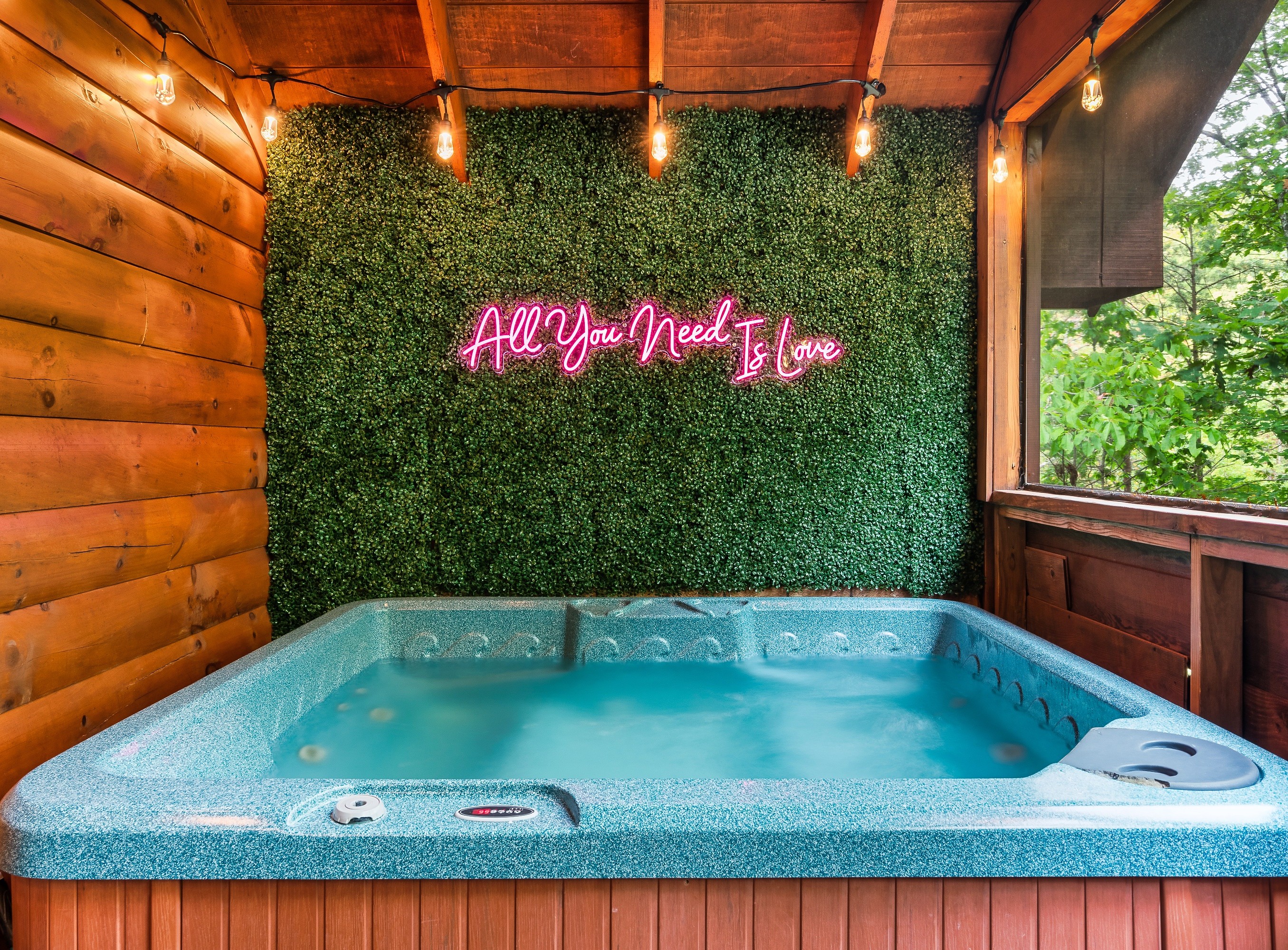 Covered hot tub in a screened in porch, ready for a soak year round, rain or shine