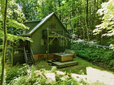 Secluded forest cabin with hot tub, balcony, and cozy outdoor charm