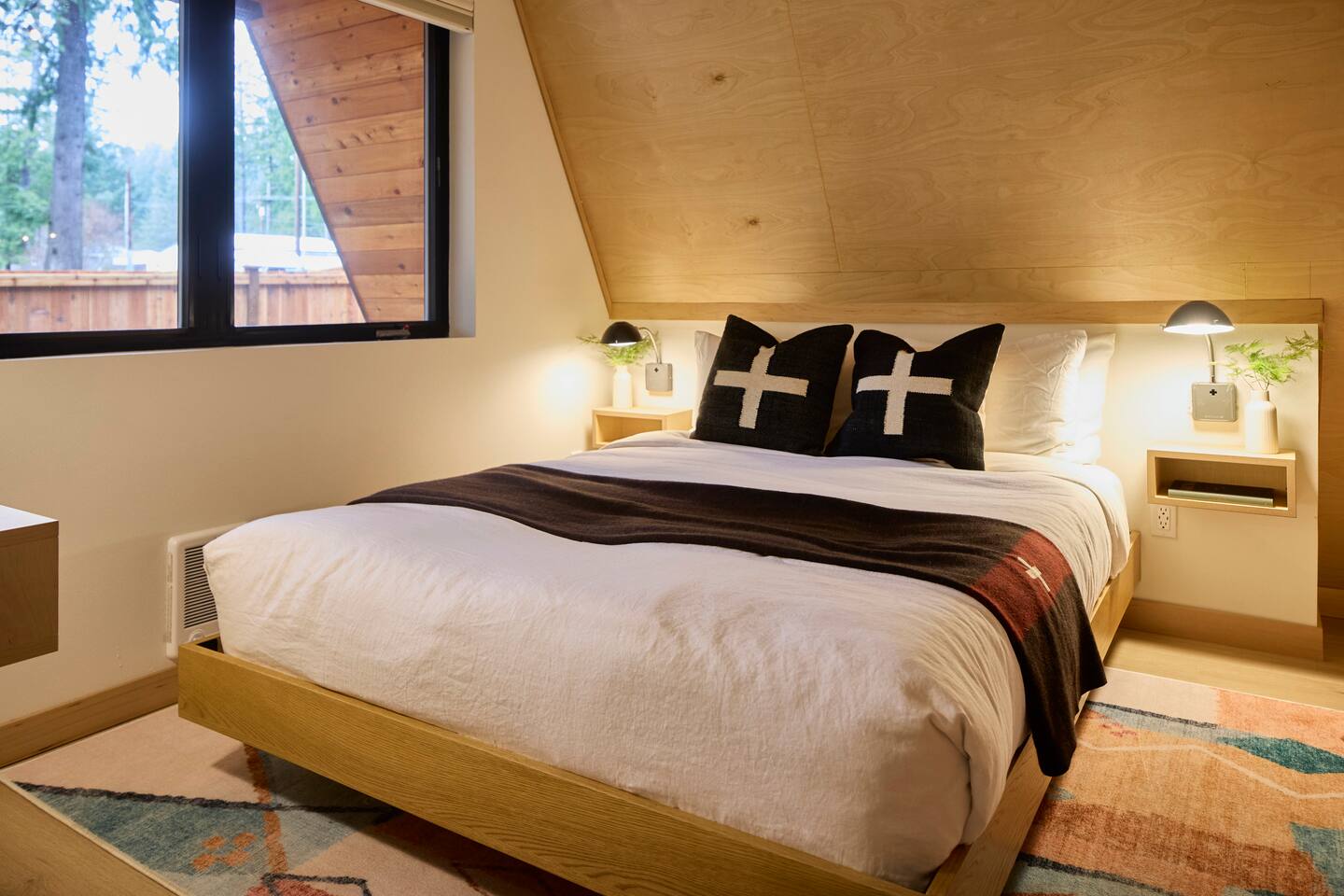 Lower bedroom with a queen bed, work space, and Frame TV