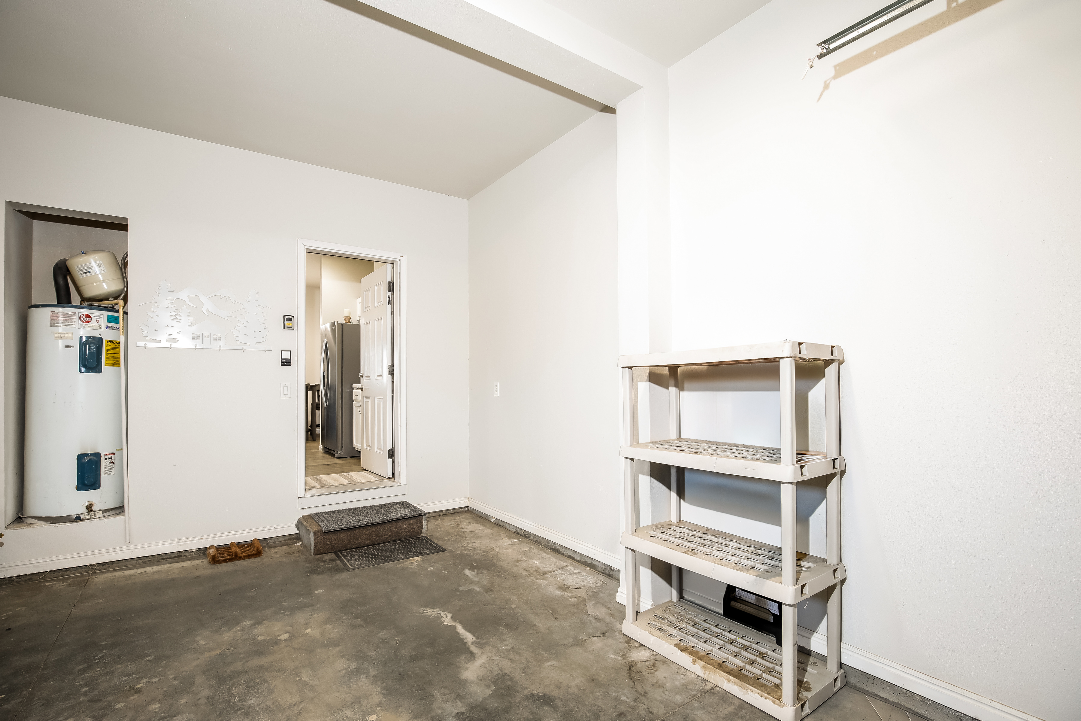 Convenient garage entry with shelving and direct access to laundry