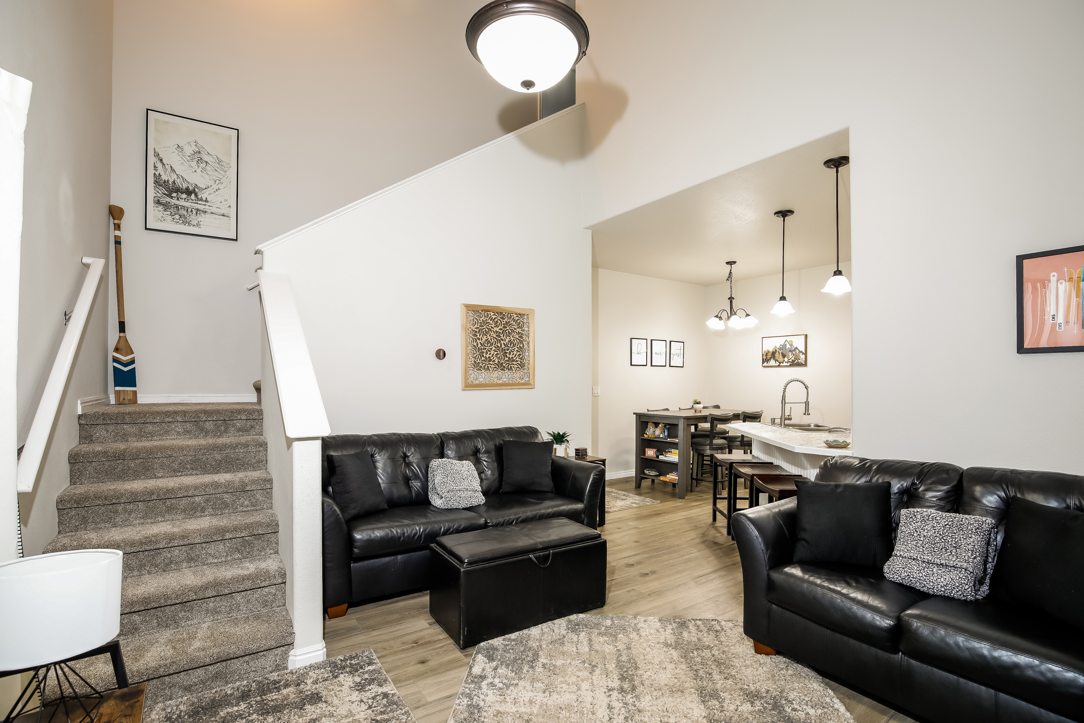 Bright open living area with leather sofas, island & dining nook