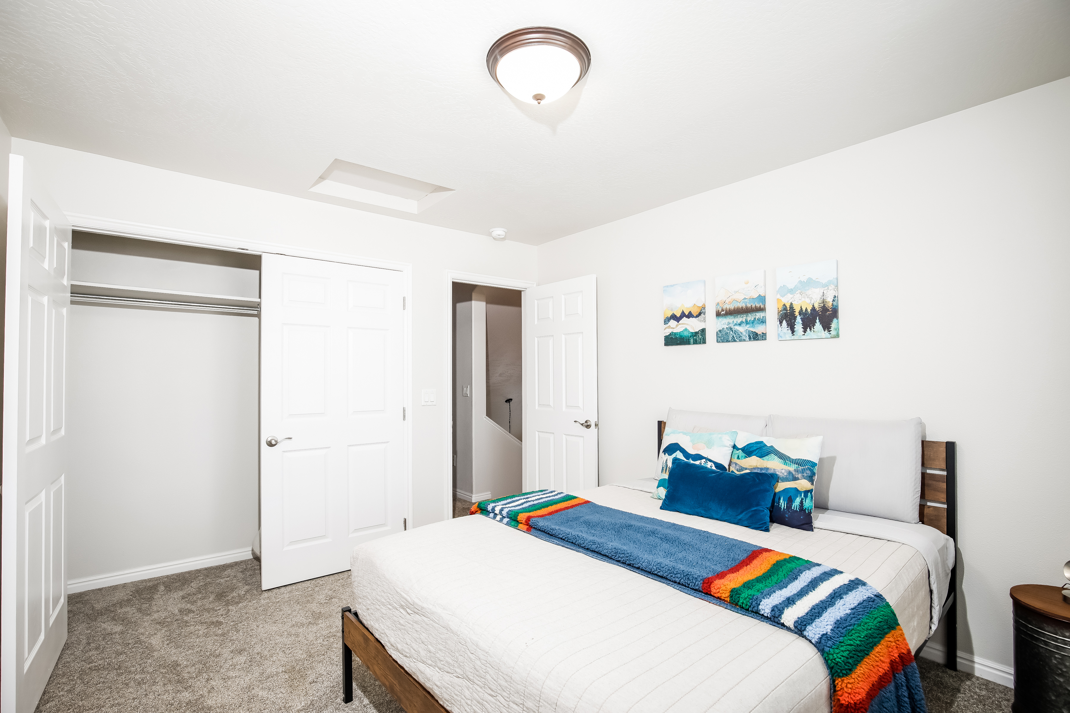 Bright, cozy bedroom with mountain decor and a large closet