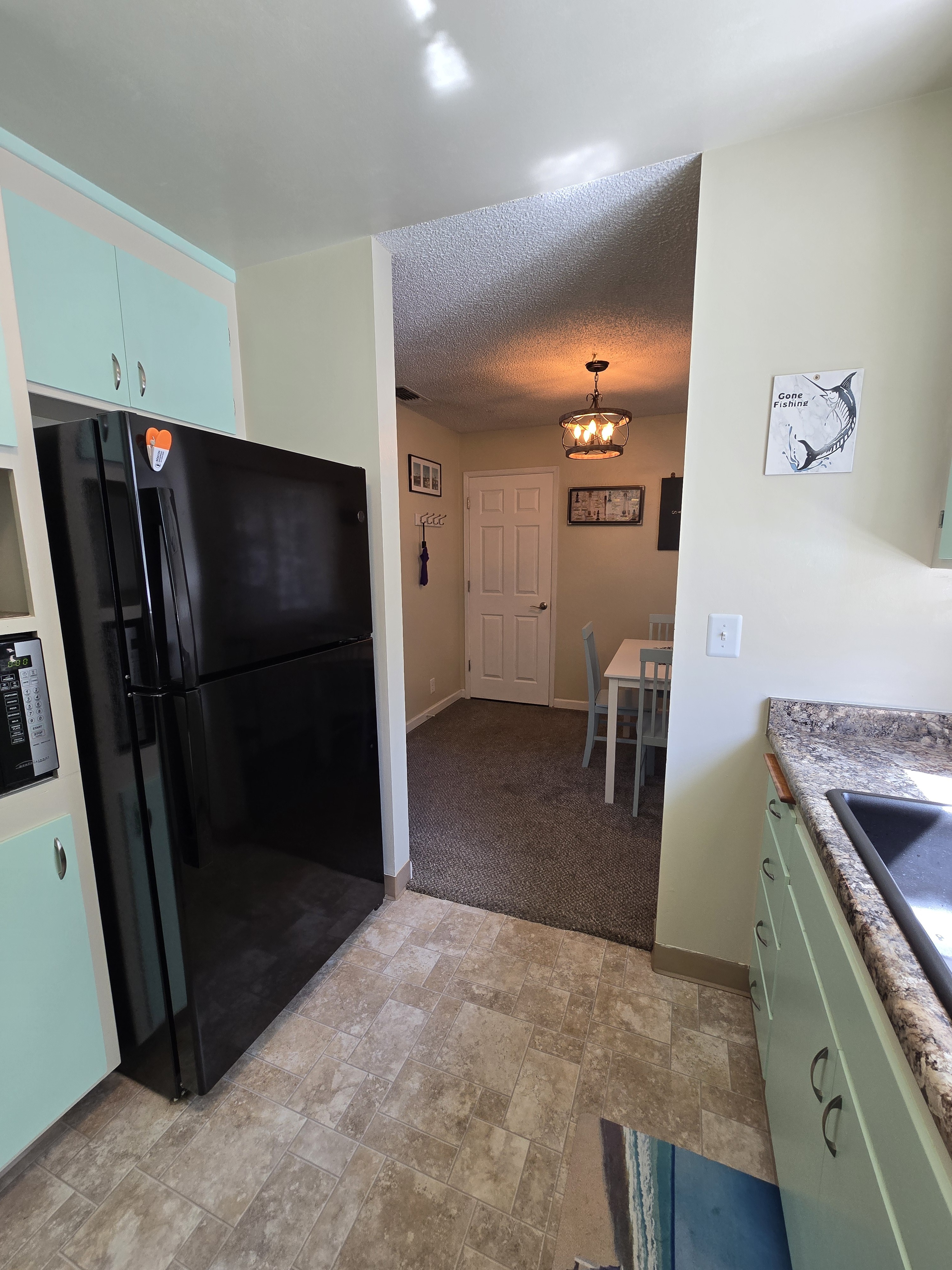 Bright kitchen with full-size fridge and cozy adjoining dining nook